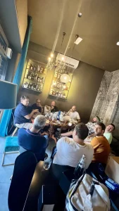 Il gruppo prima dell'apertura davanti a un tavolo con salumi